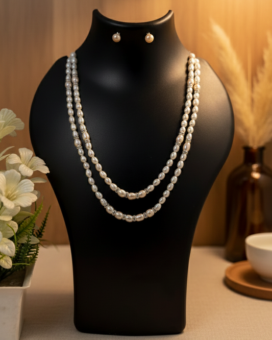 Pearl necklace on a black mannequin bust with a soft background