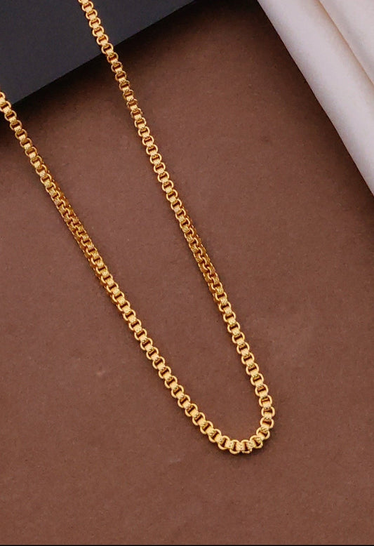 Gold chain on a brown surface with a blurred background