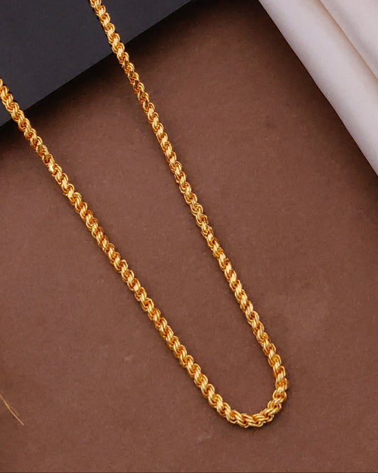 Gold chain on a textured surface with a blurred background